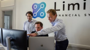 Limina team members discussing and looking at a screen